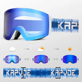 Photochromic snow goggle with a white frame, black face foam and a blue photochromic lens in its light state, on a blue-and-white patterned strap with white brand lettering. Three small goggles show the lens darkening to a deep blue mirror from cloud to sun.