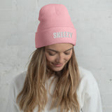 Woman wearing the baby pink Skeezy cuffed beanie with white SKEEZY embroidery
