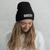 Woman wearing the black Skeezy cuffed beanie with white SKEEZY embroidery
