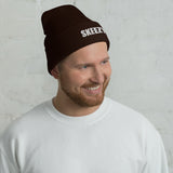 Man wearing the brown Skeezy cuffed beanie with white SKEEZY embroidery