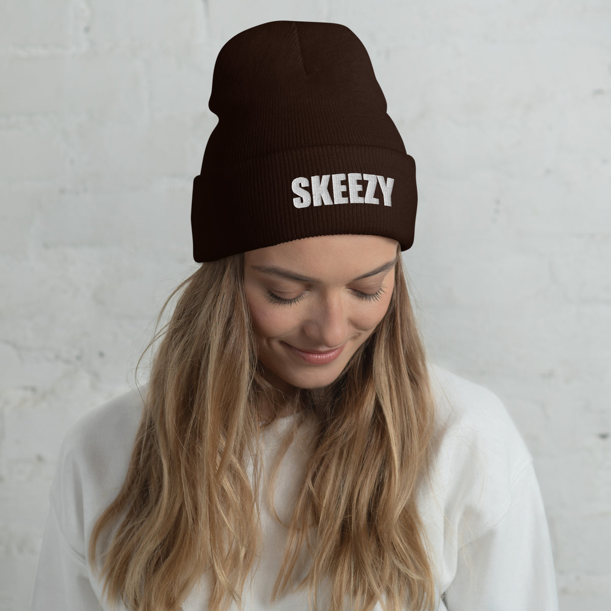 Woman wearing the brown Skeezy cuffed beanie with white SKEEZY embroidery