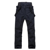 Highline Women's Suspender Snow Pant in Black, front view, laid flat with the suspenders showing