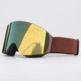 Snow goggle with a brown matte frame, gold mirror lens and brown textured strap, side view
